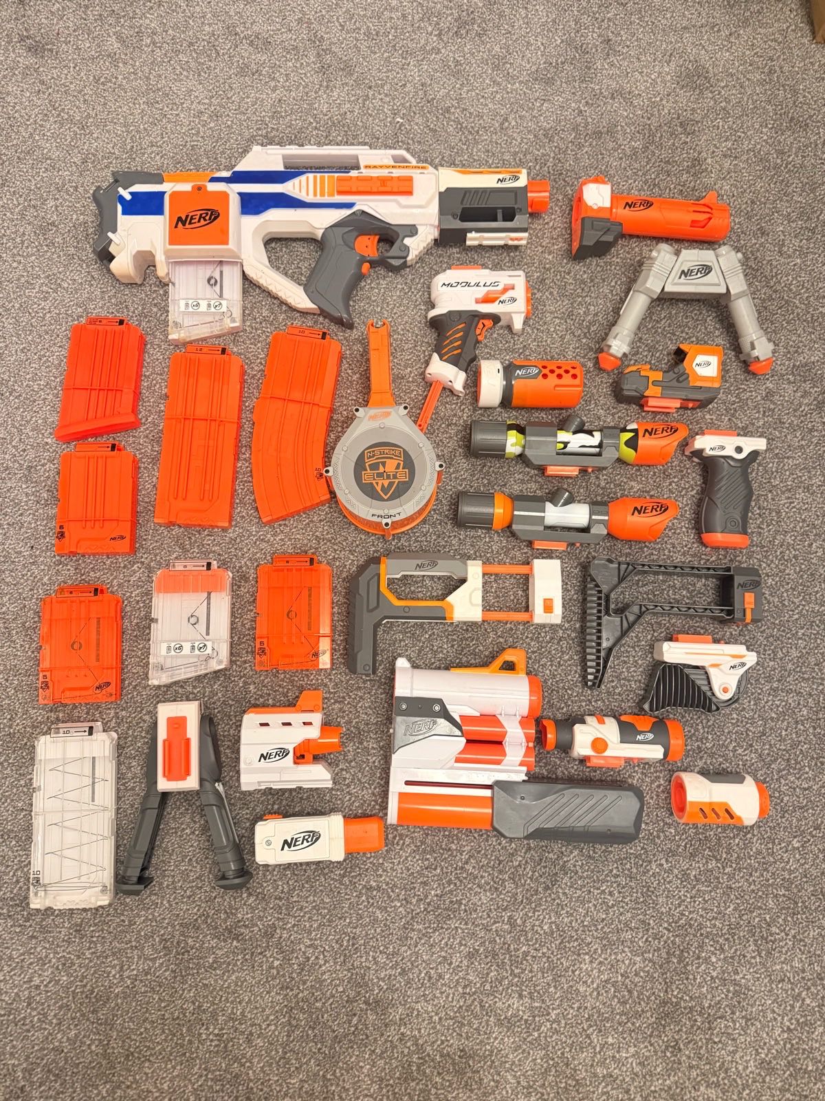 Nerf N-Strike Rayven CS-18 blaster alongside various Modulus and N-Strike tactical attachments, scop