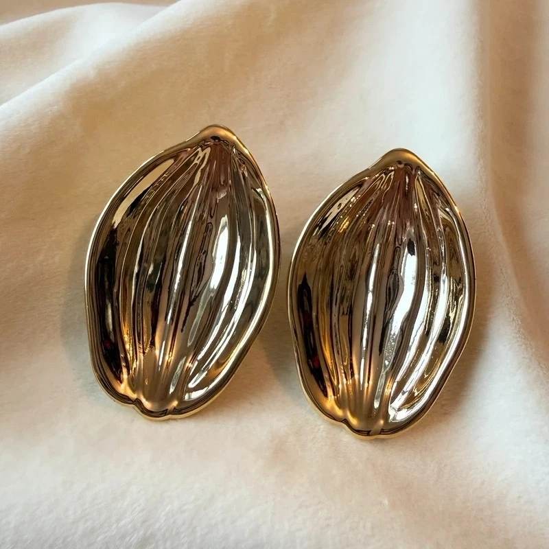 gold tone ribbed earrings organic shape statement earrings polished textured earrings