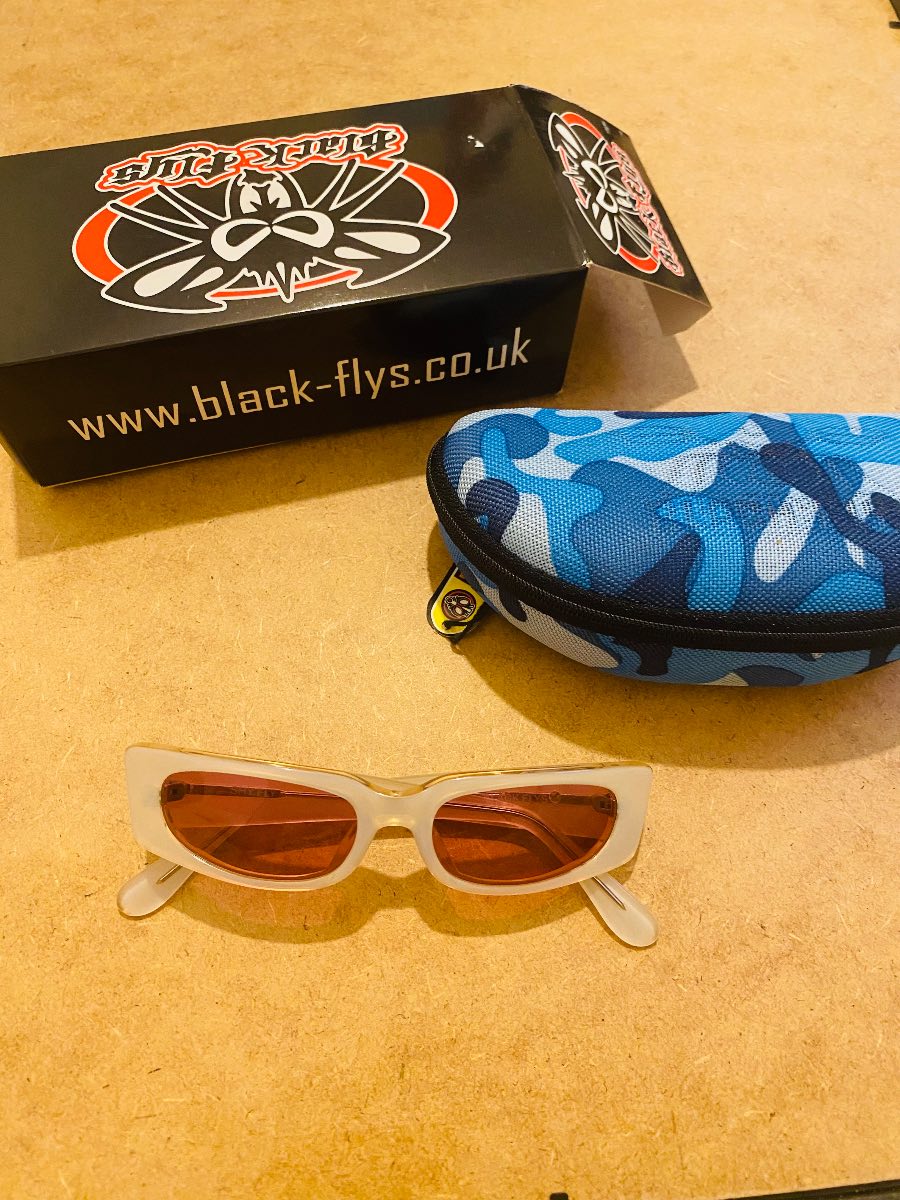Black flys pink and white sunglasses