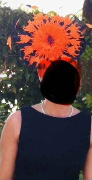 Handmade striking black sinamay with bright orange flower and quils