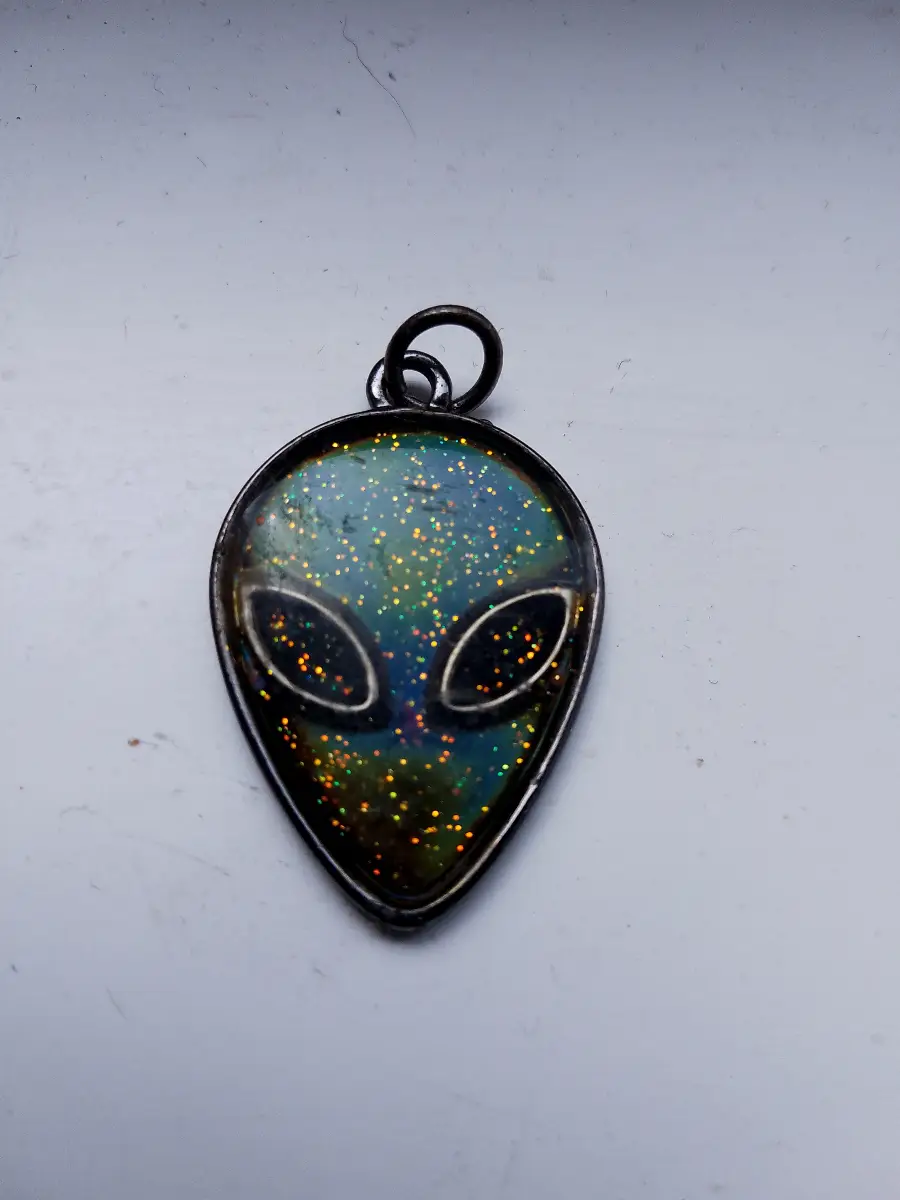 Small metal and enamel sparkly alien pendant