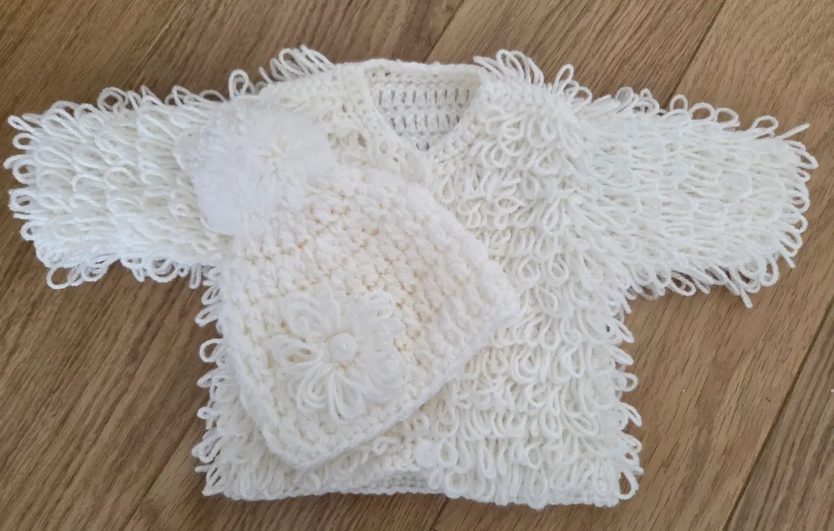 Handmade baby girls cream loopy matching cardigan and pom pom hat set.