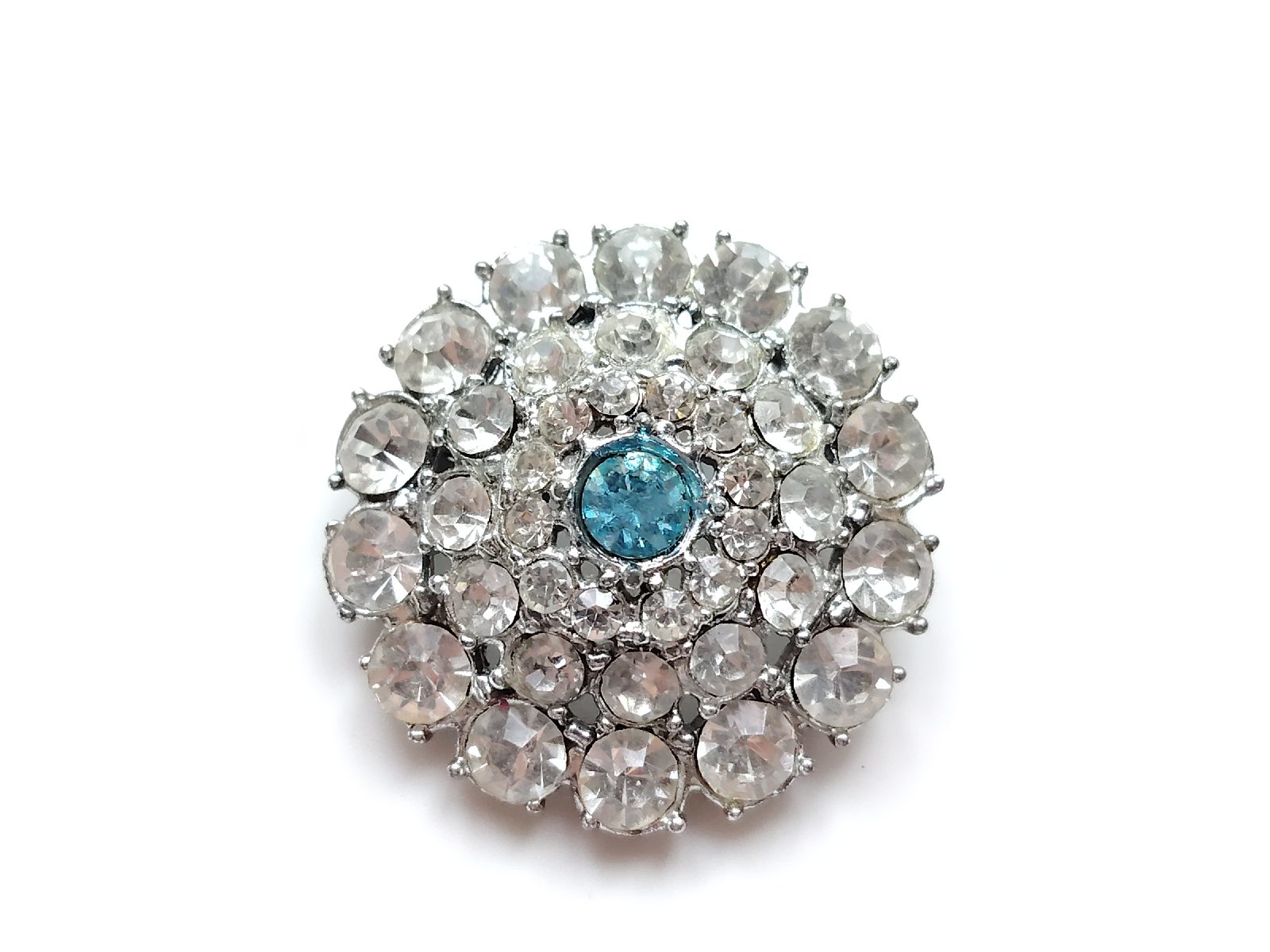 Silver tone metal  blue rhinestone circle brooch