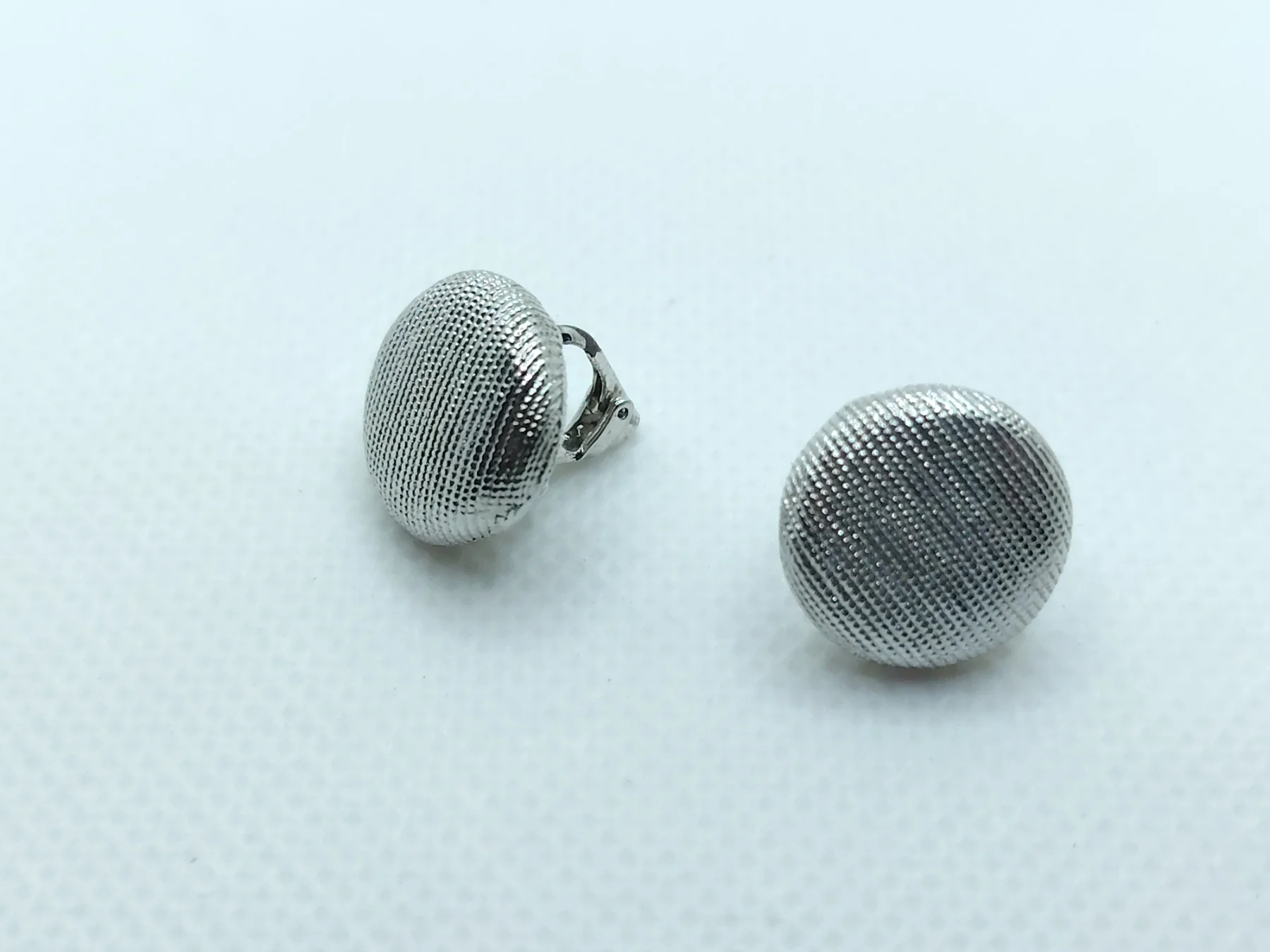 Retro style silver tone textured clip on earrings