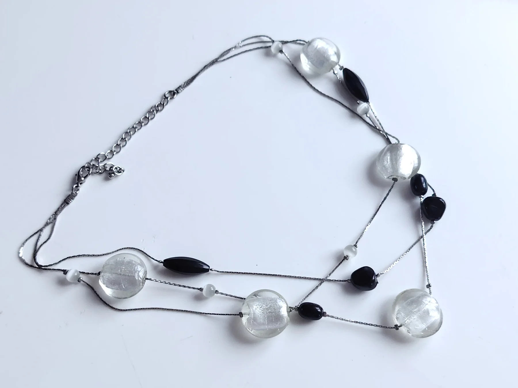 Silver tone triple strand foil glass bead necklace