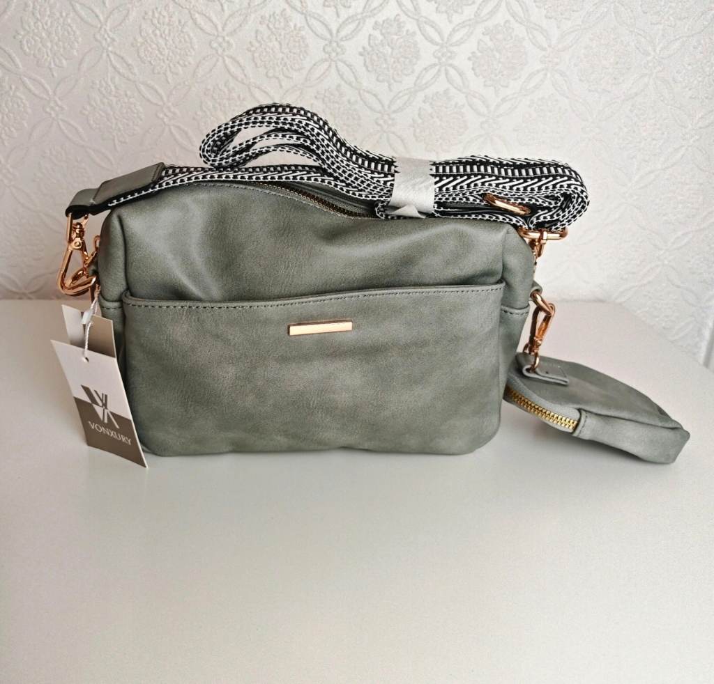Vonxury vegan leather crossbody bag in a greyish-green color featuring a patterned canvas strap