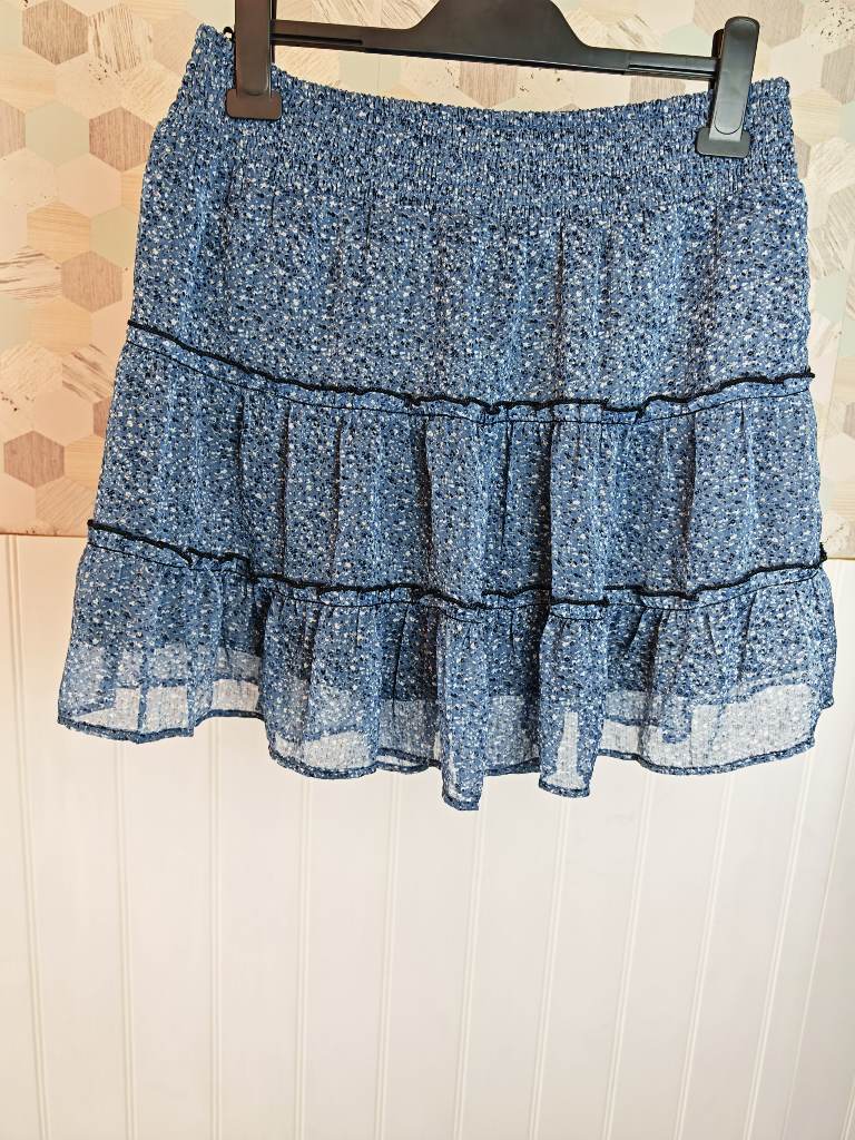 Primark blue ditsy floral mini skirt, smocked waist and tiered ruffles, black piped detailing | Size