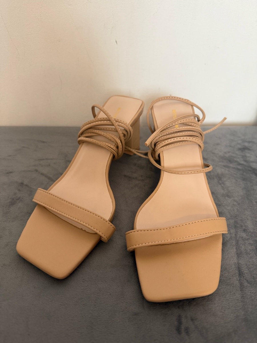 Beige strap around heels