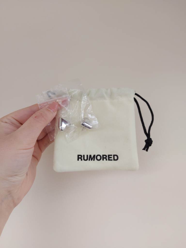 Rumored silver colour heart stud earrings with pouch