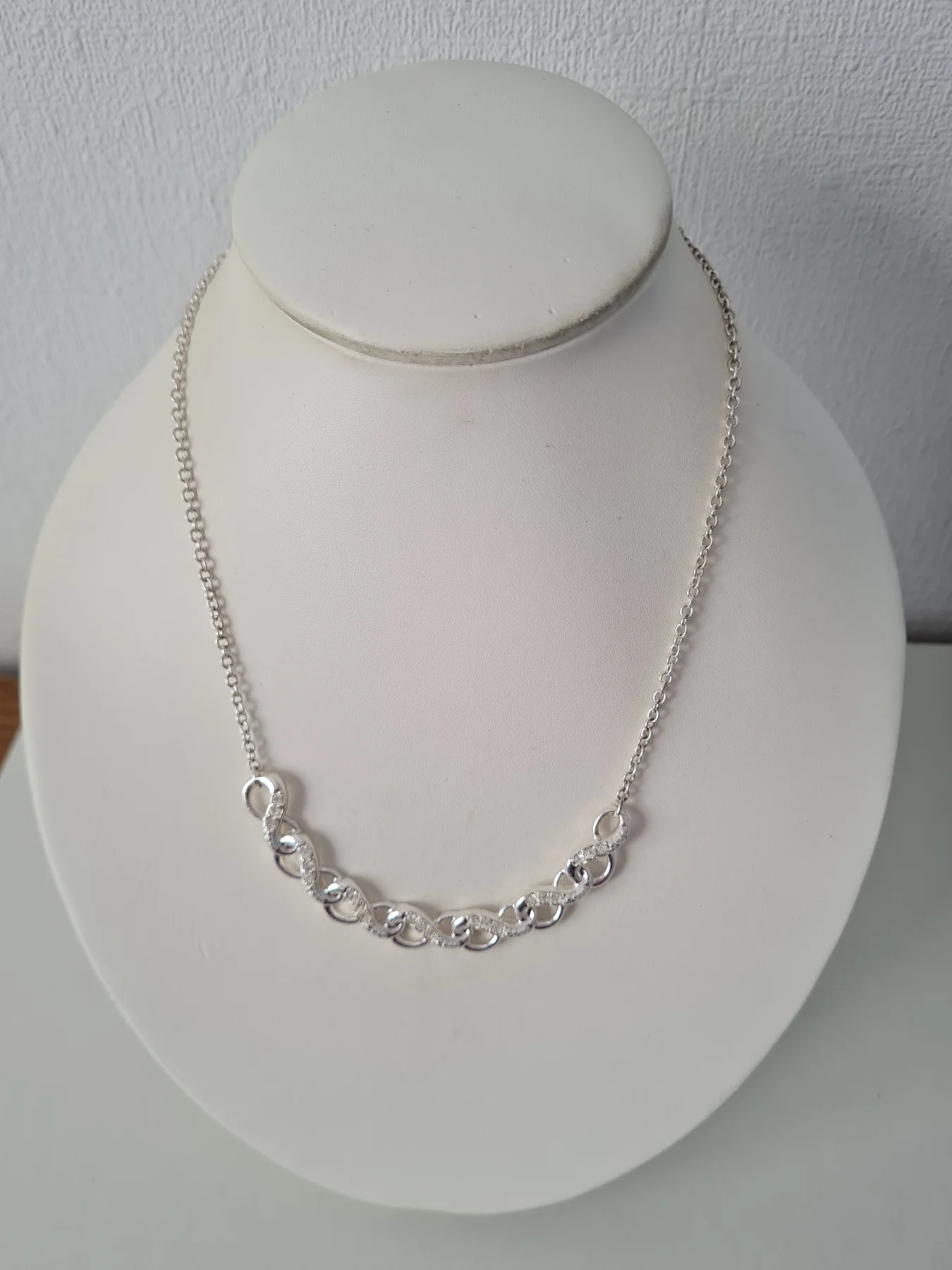 Silver tone Infinity collar rhinestone necklace