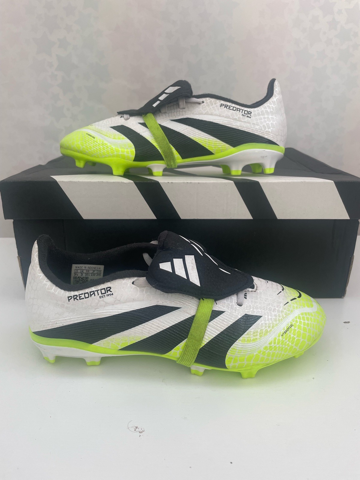 Adidas Predator League Fold-Over Tongue football boot features a white, black, and lucid lemon