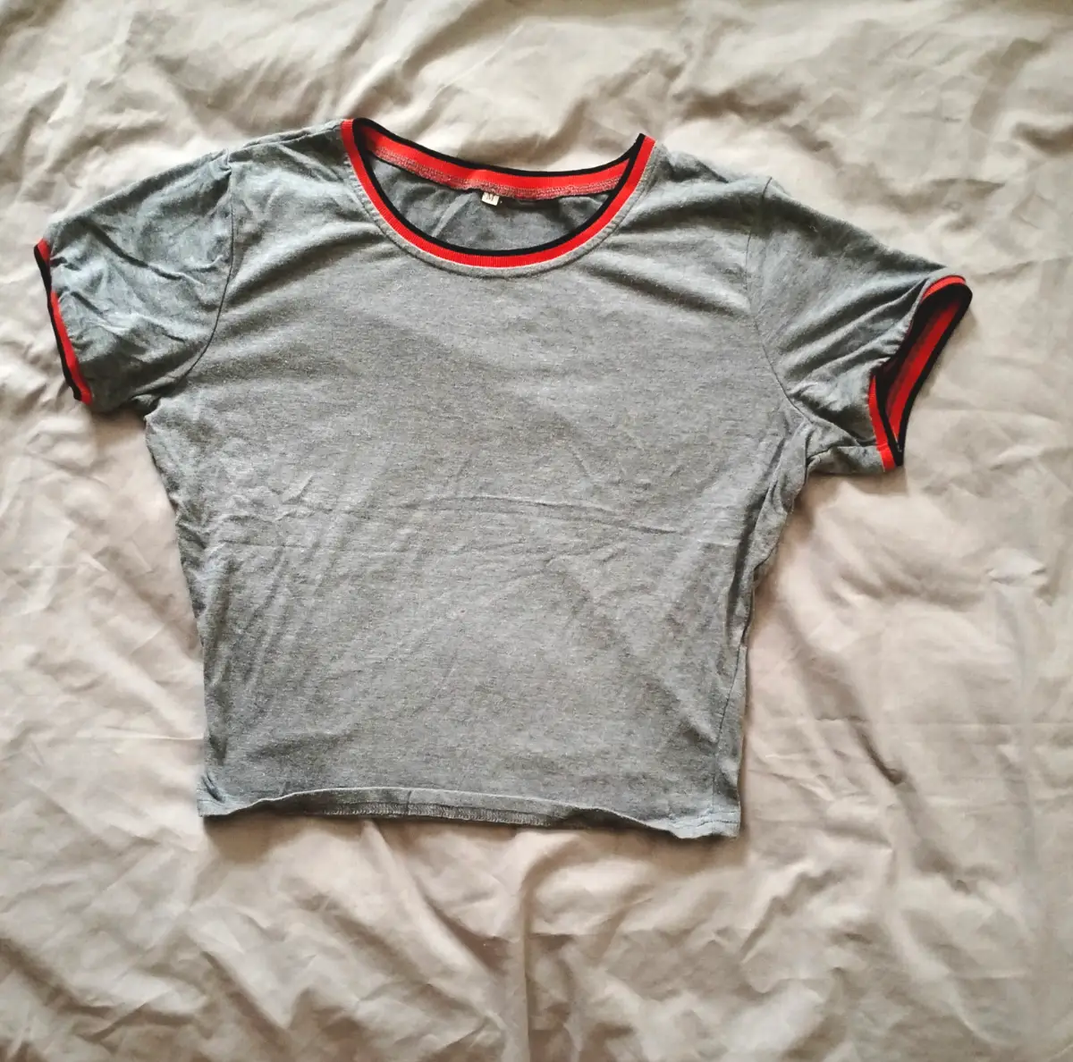 Gray crop top with red trim on neckline and sleeves Size: M