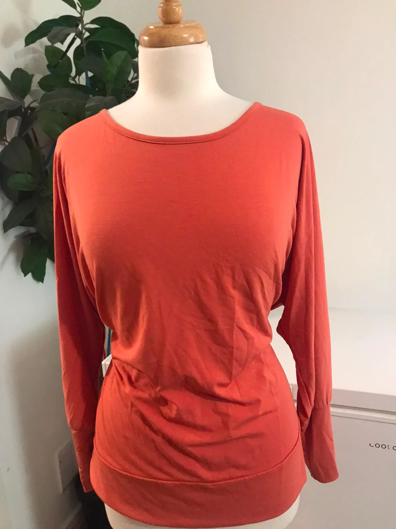 coral-orange long-sleeve top