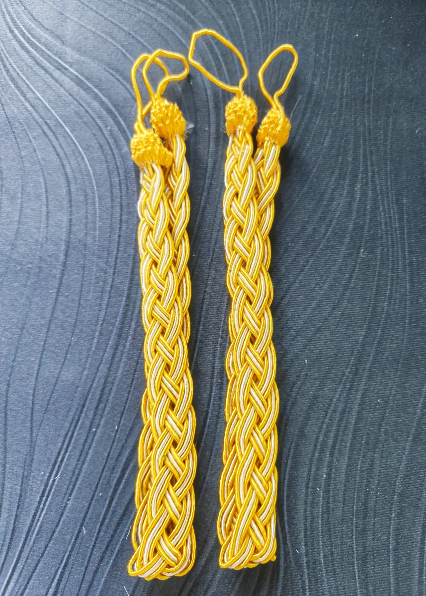 Pair of gold braided curtain tie backs