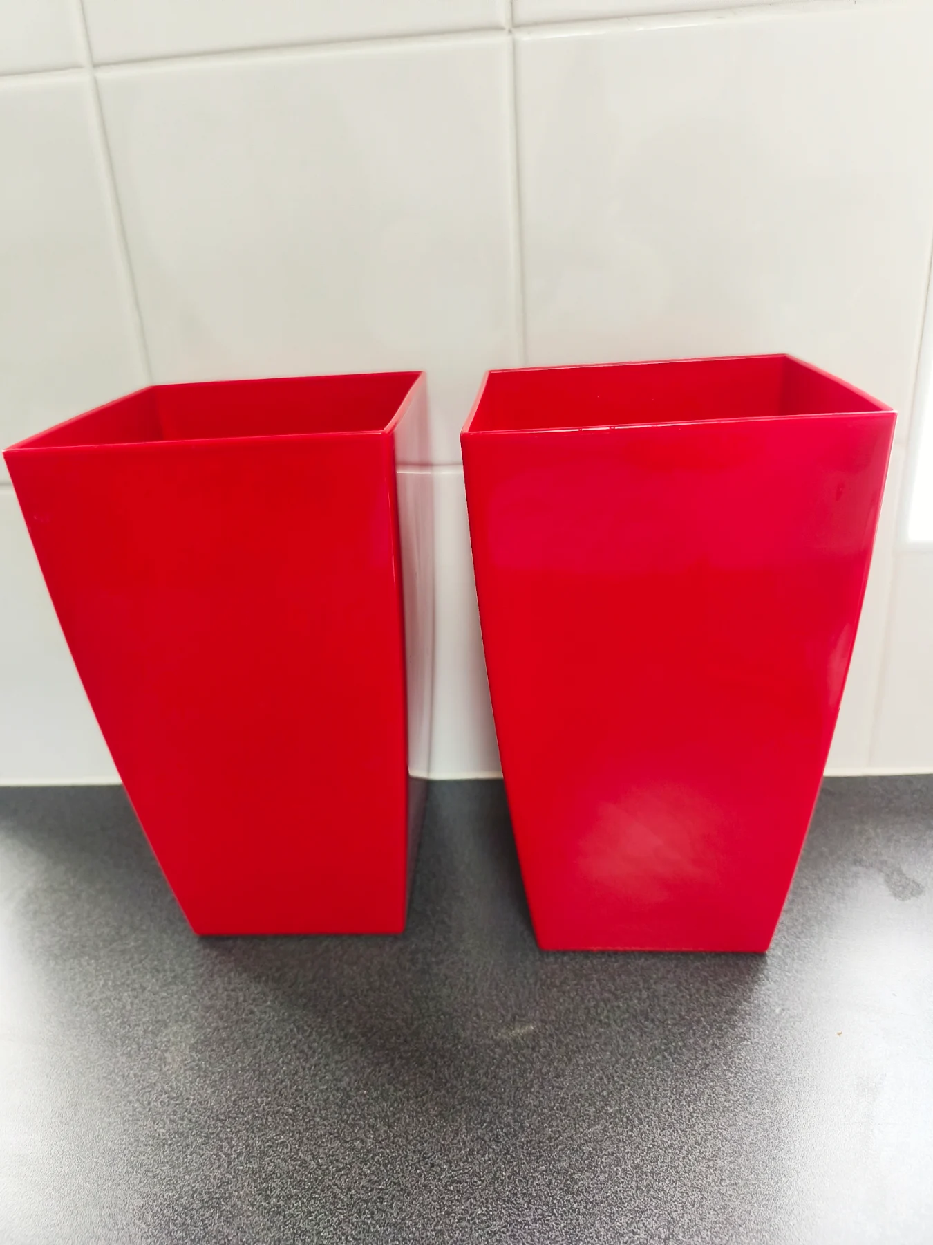 2 red lightweight plastic plant pot holders
