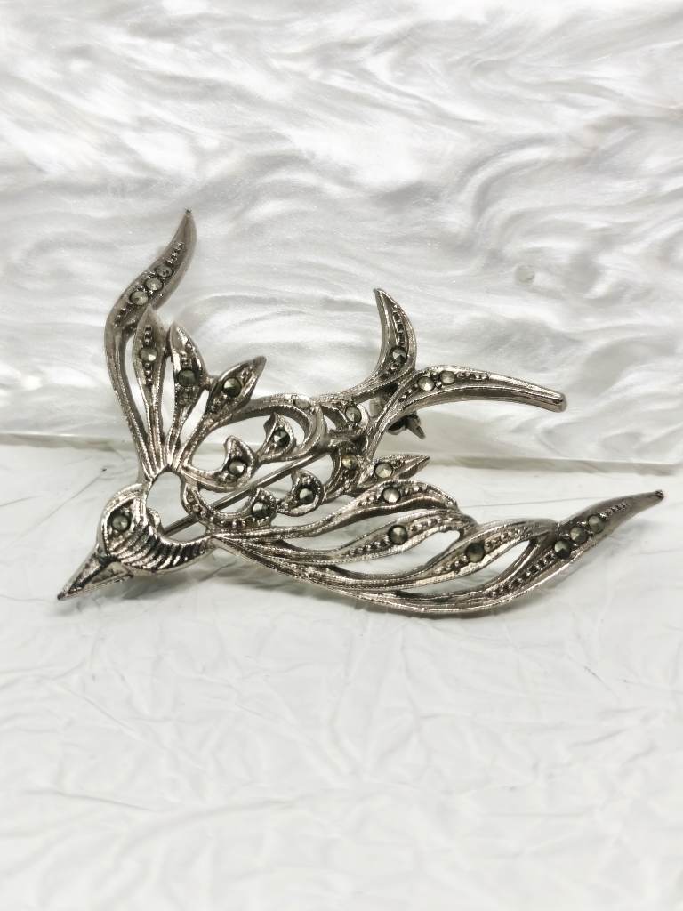 Silver tone bird brooch with marcasite gems