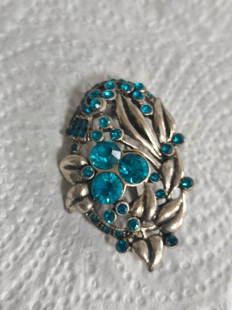 Silver tone with blue gems brooch