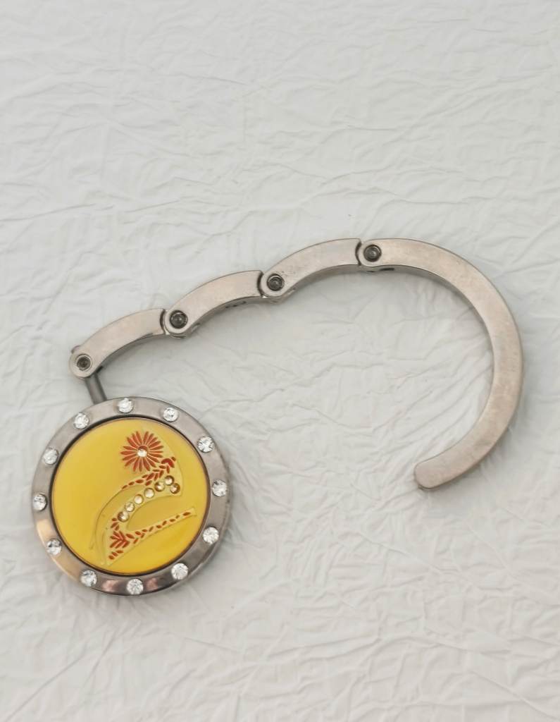 Weighted bag hook with stiletto design