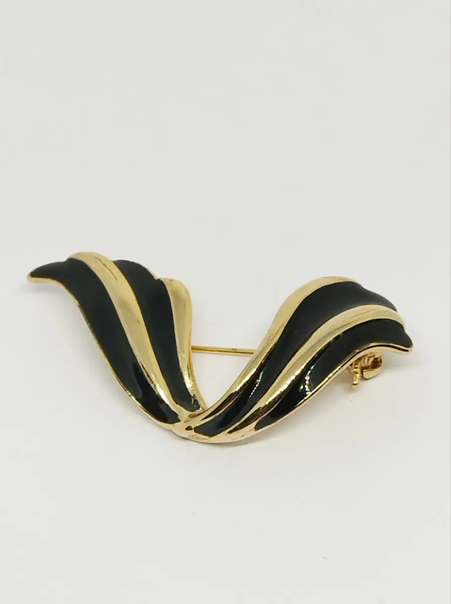 Gold tone & black enamel swish brooch