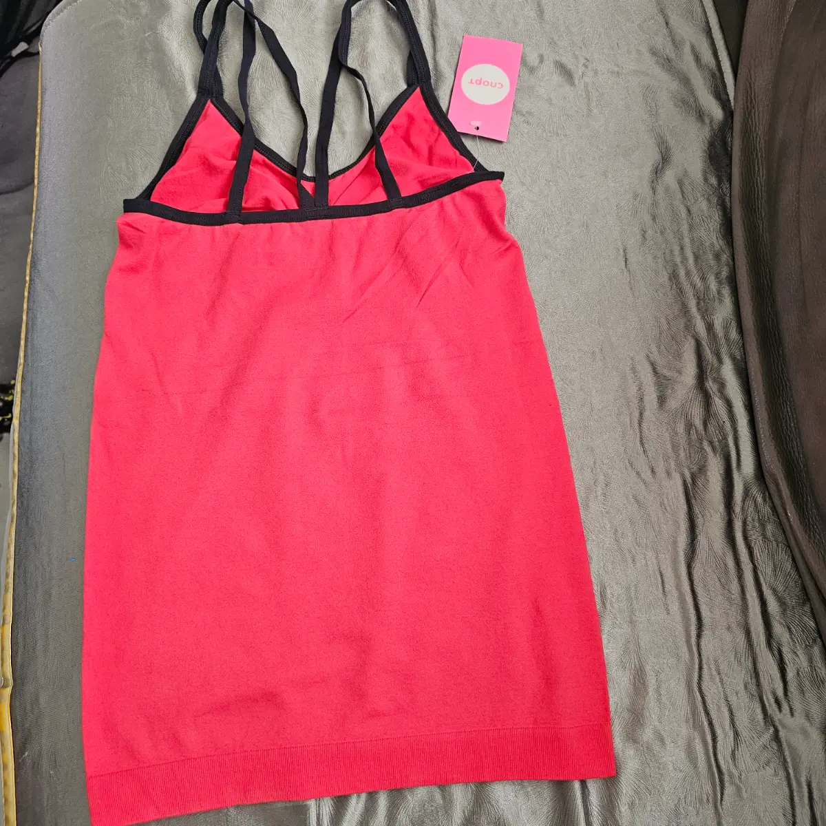 TBOE seamless cami vest top with built-in bra in a bright pink colour with black contrast straps.