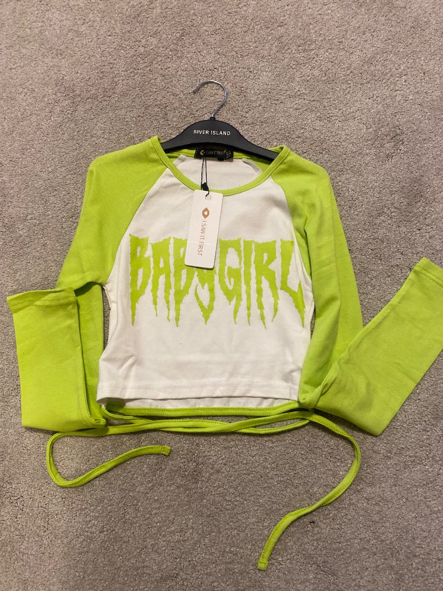lime green and white graphic raglan tee featuring a stylized "BABYGIRL"