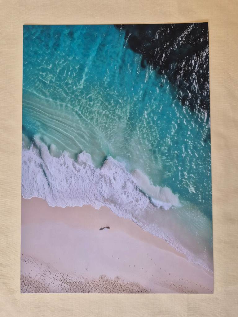 aerial beach print featuring turquoise ocean water and a sandy shore.