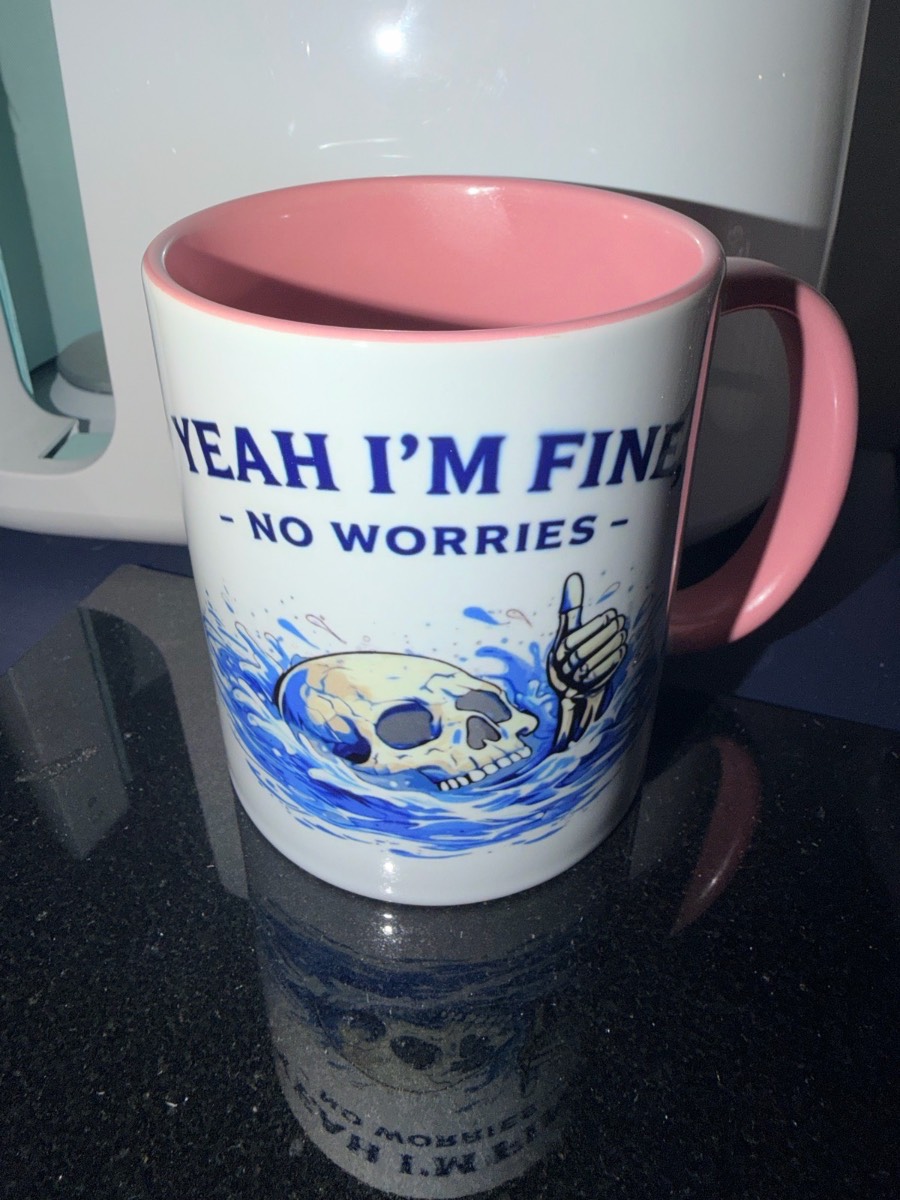 Brand new- pink inside and handle funny skeleton witty mug with saying “yeah I’m fine, no worries”