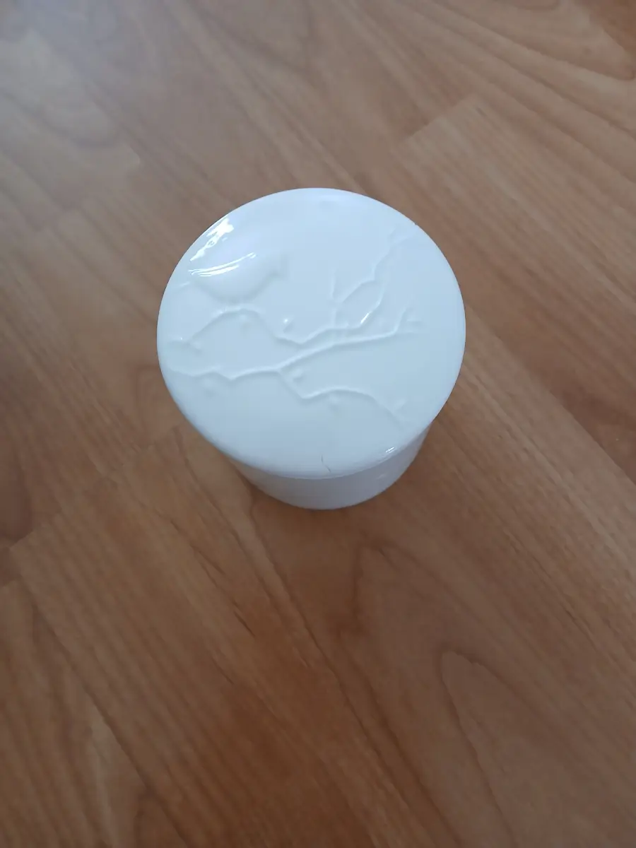 Candle in white pot container