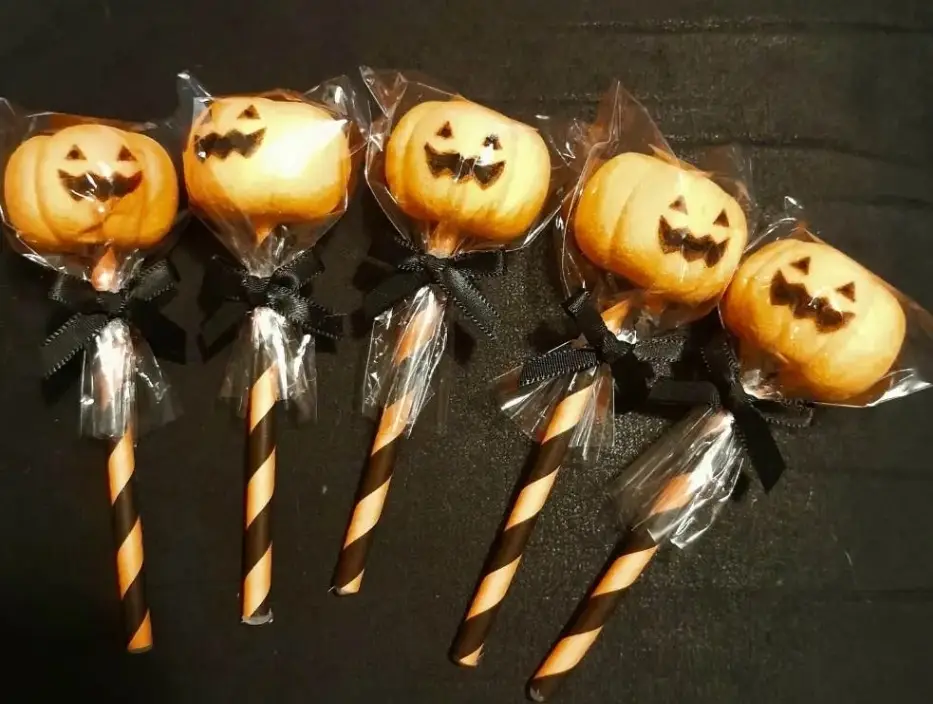 Faux halloween lolly decorations.  Plastic pumpkin  heads