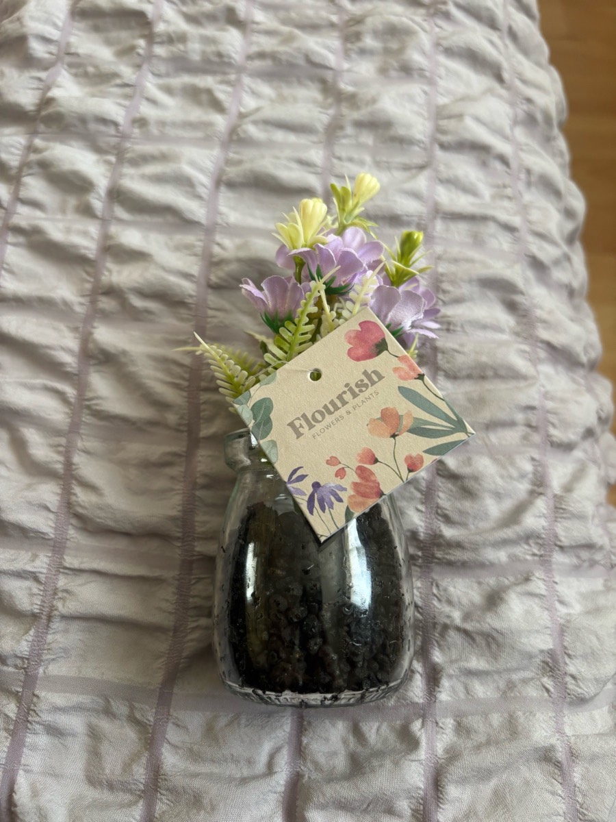 Glass vase with plastic flowers ornament