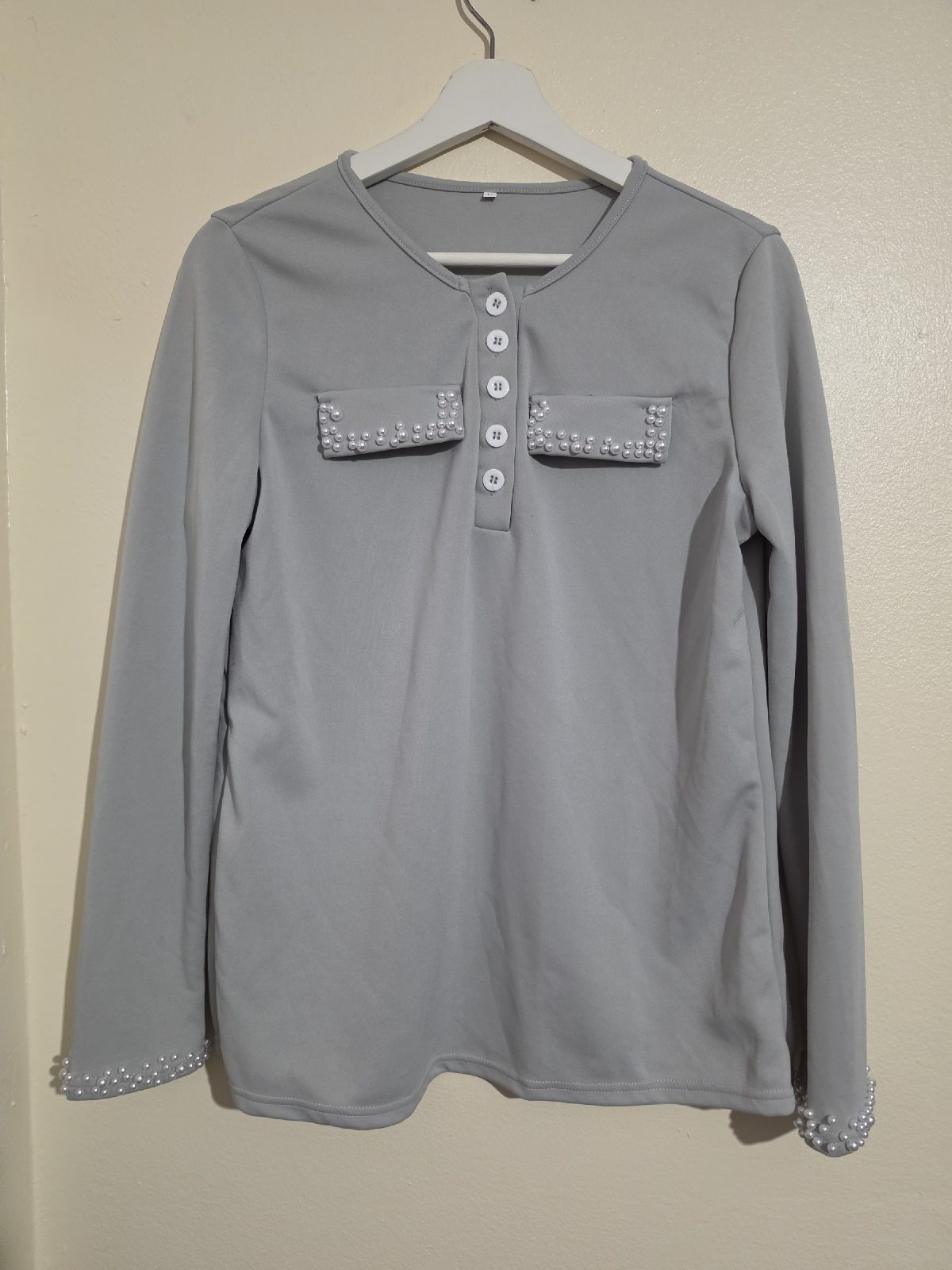 15. Womens size large light grey long sleeved round neck top, buttons at neck, imitated pockets, VGC