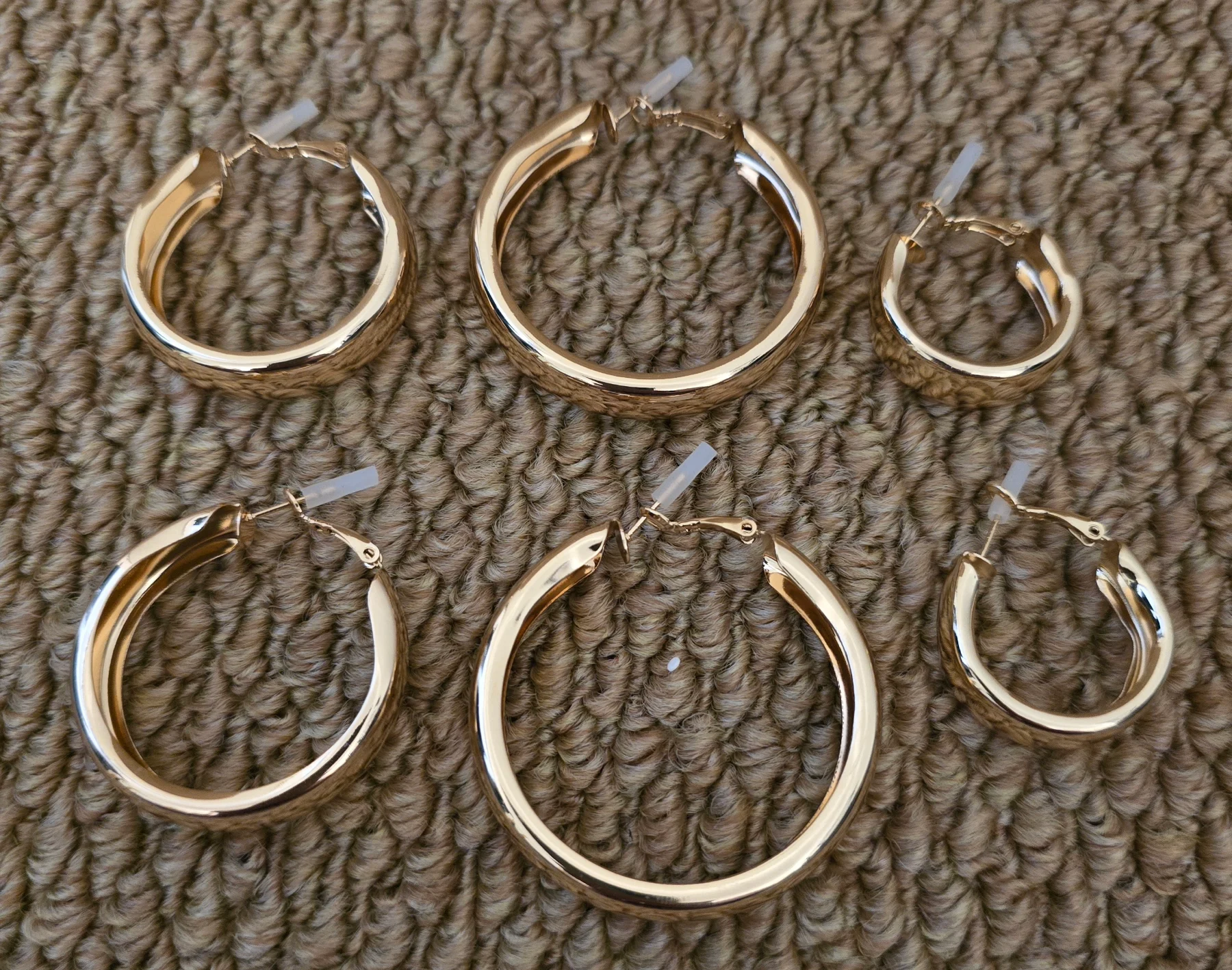 Set of 3 Pairs of Chunky Gold Tone Hoop Earrings.