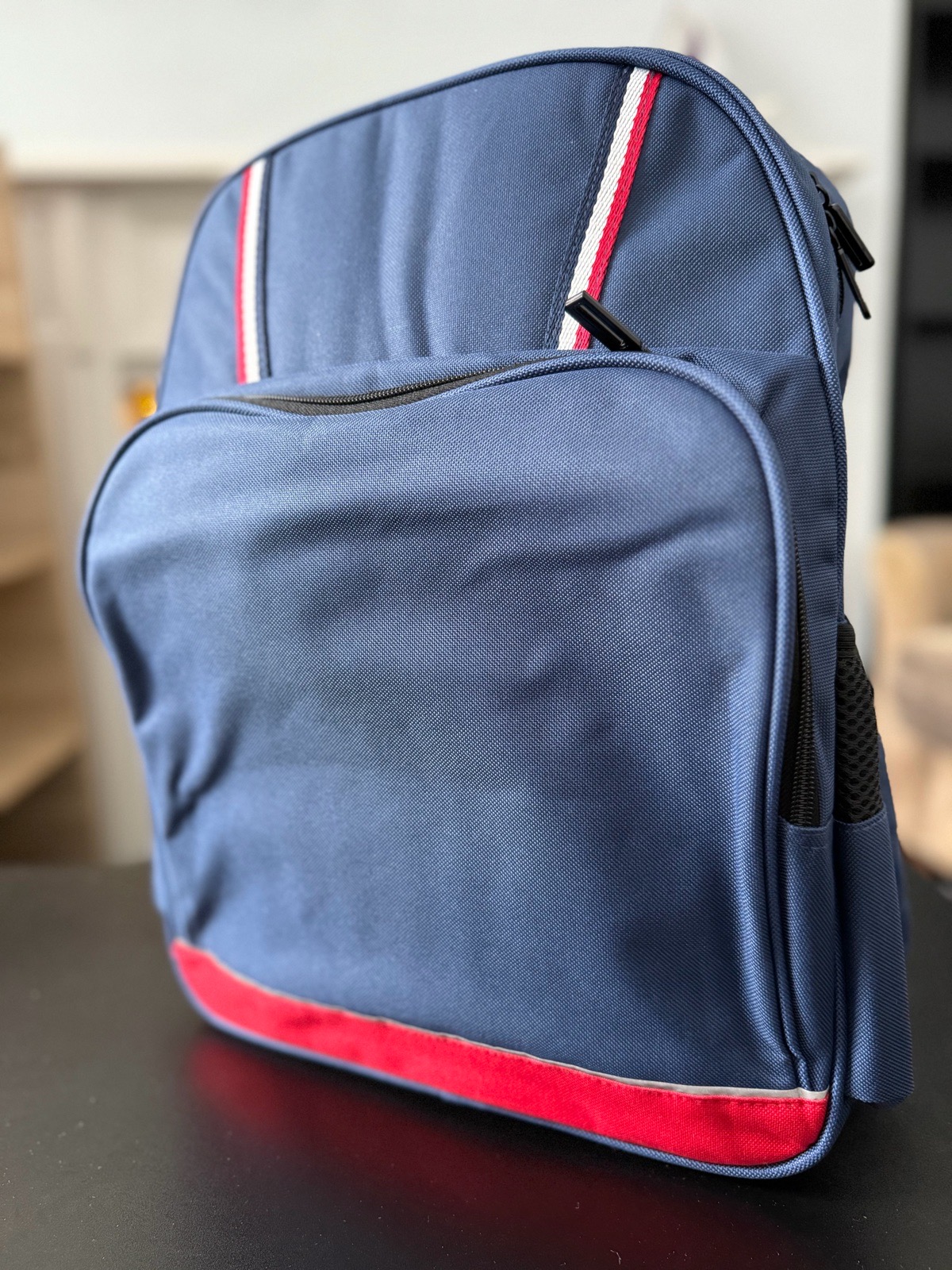 Stylish Blue Backpack with Red & White Stripes