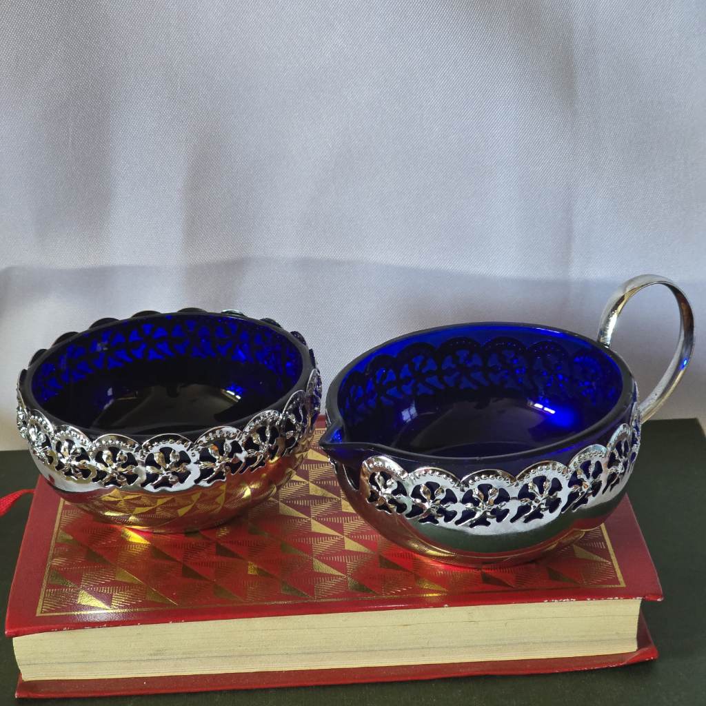 blue glass in silver coloured holders milk and sugar set vintage