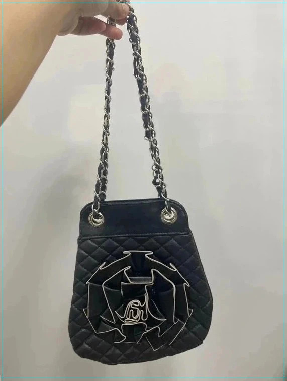 Black quilted leather flower bag with silver chain adjustable strap