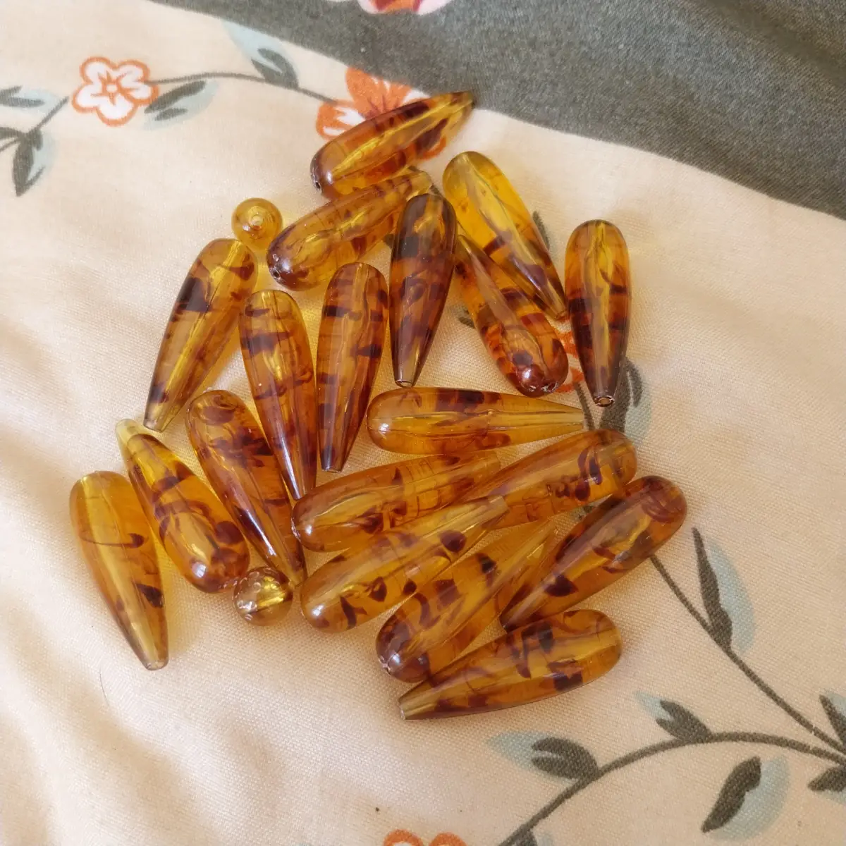 Teardrop shaped beads amber and black coloured