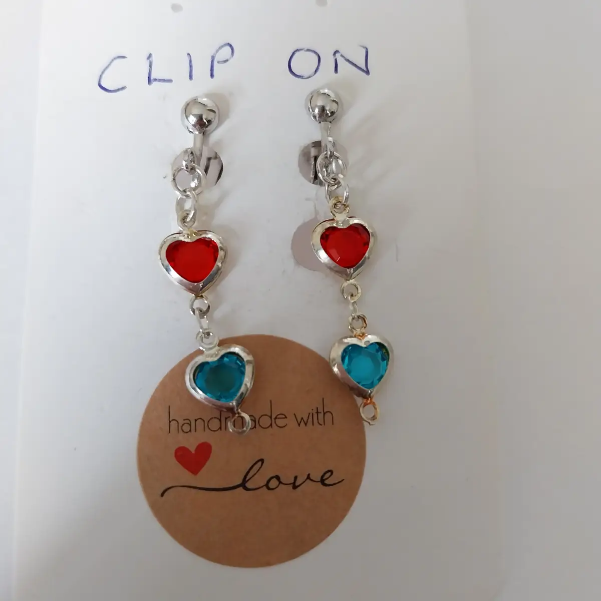 Clip on earrings with red and blue heart drops