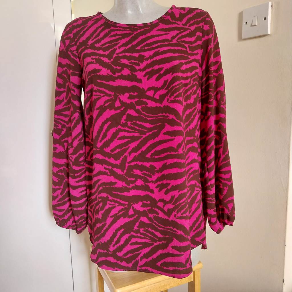 Black and pink patterned top with elasticated cuffs