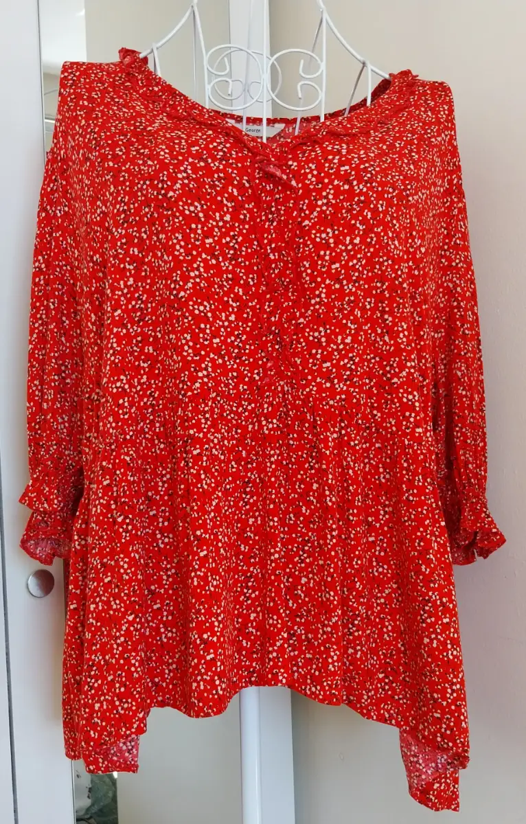 Red floral top with frill at neckline and front