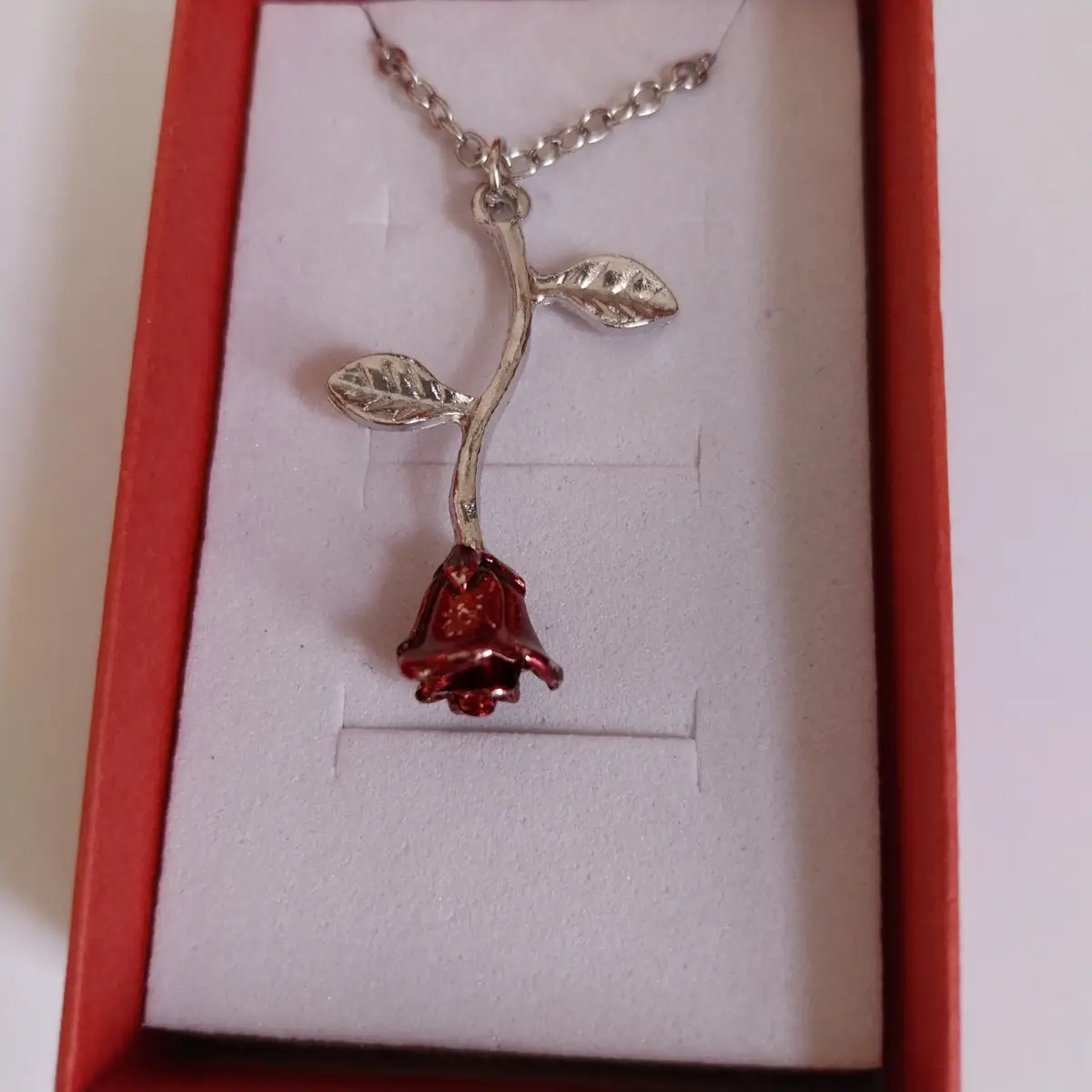 Silver and red coloured rose pendant and chain