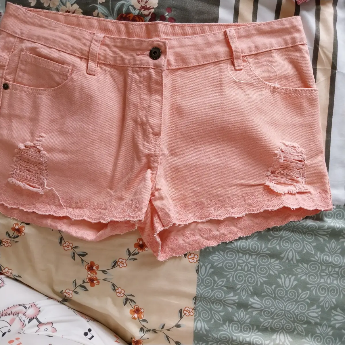 Peach coloured distressed shorts