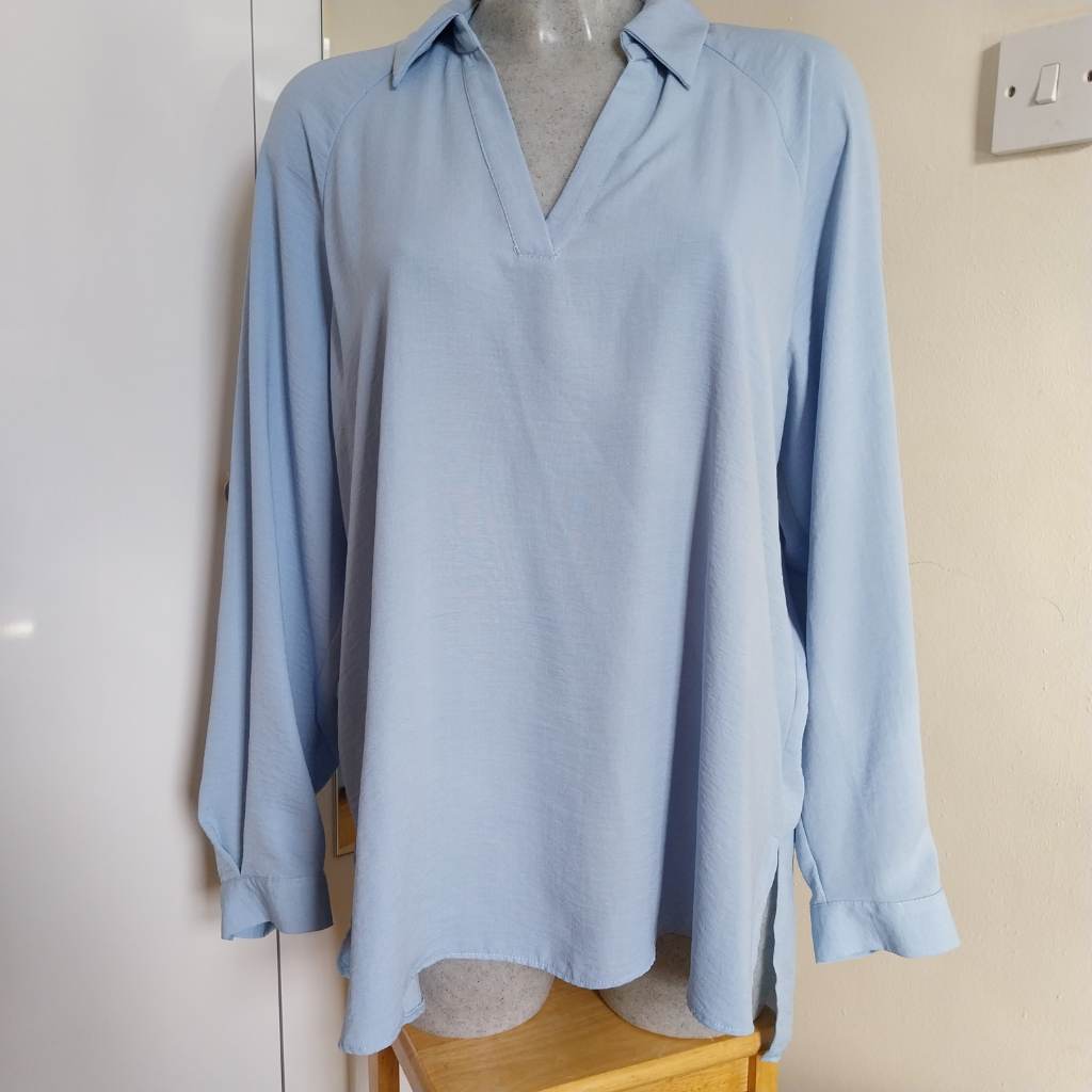 Blue top with button cuffs and collar