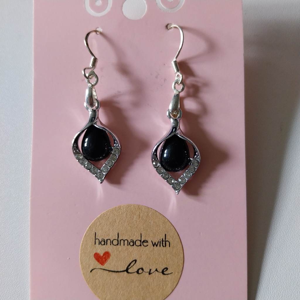 Silver coloured earrings with black center
