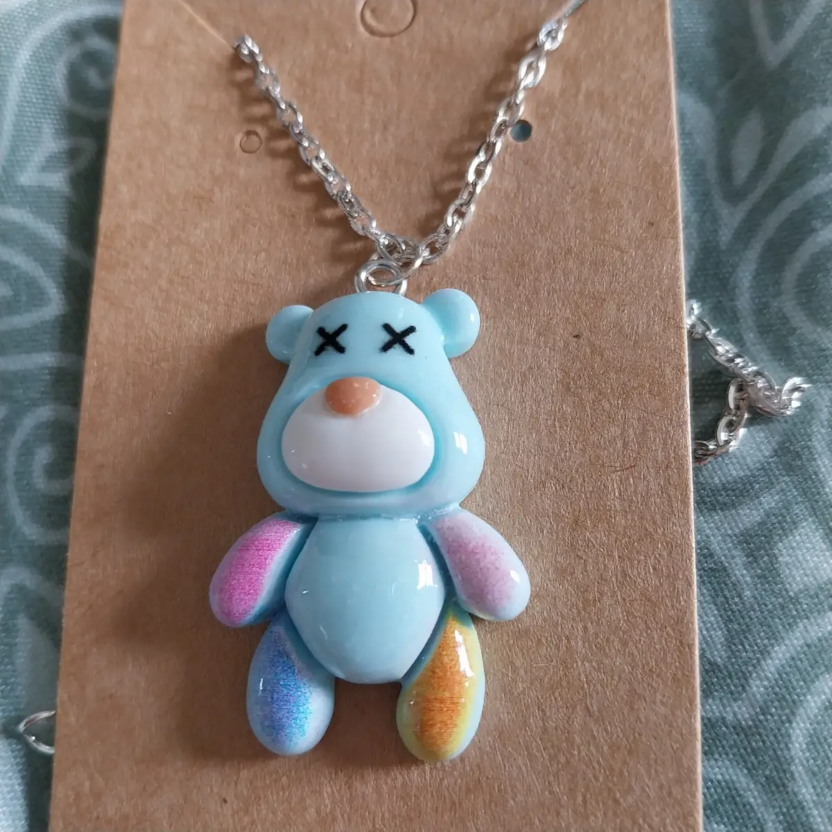 Blue bear pendant on a silver coloured chain