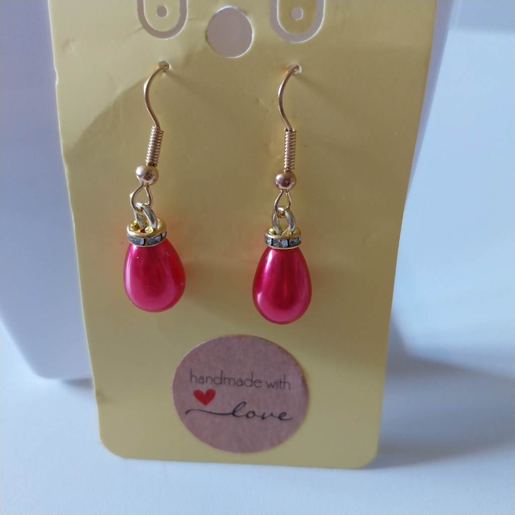 Red pearl effect earrings with gold coloured fishhook style findings