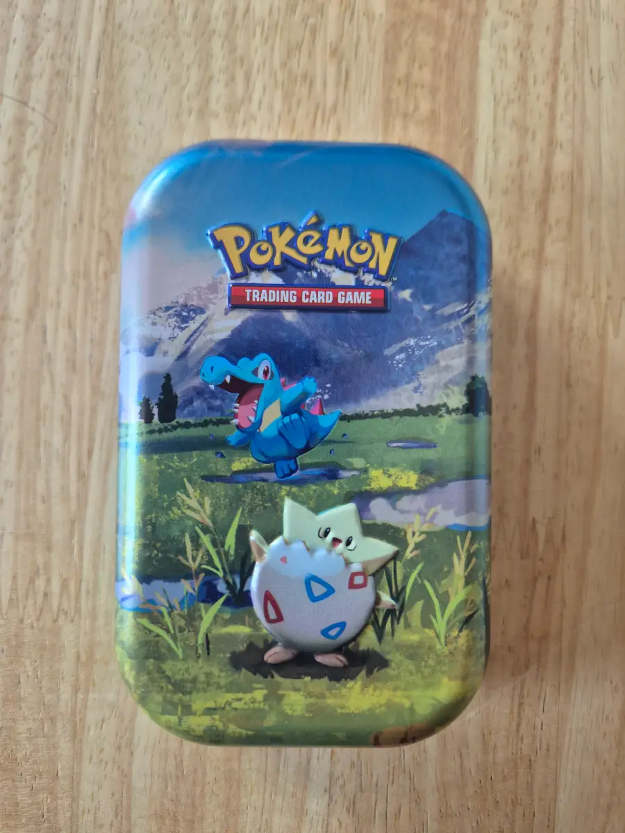 Pokémon tin with 50 cards plus EX/V card or better