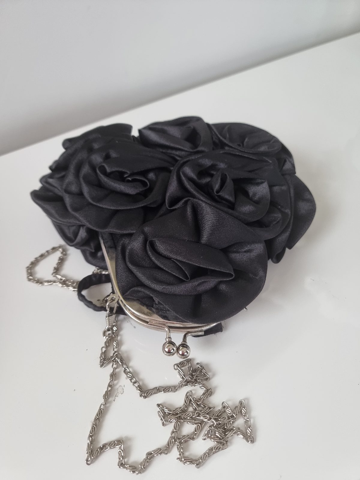 Black satin rosette clutch bag with silver chain strap