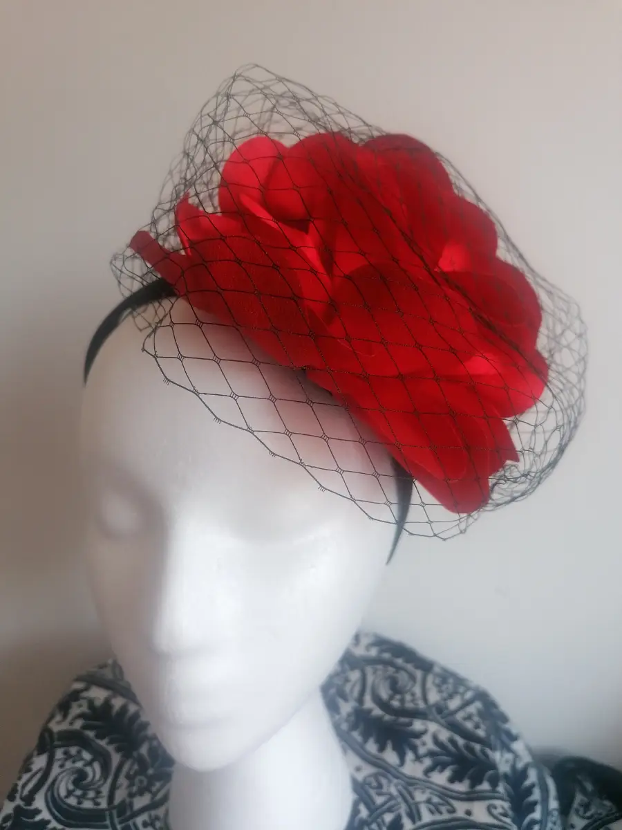 Red flowered fascinator with black net detailing