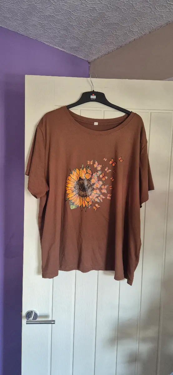 Women's brown top with flowers and butterfly