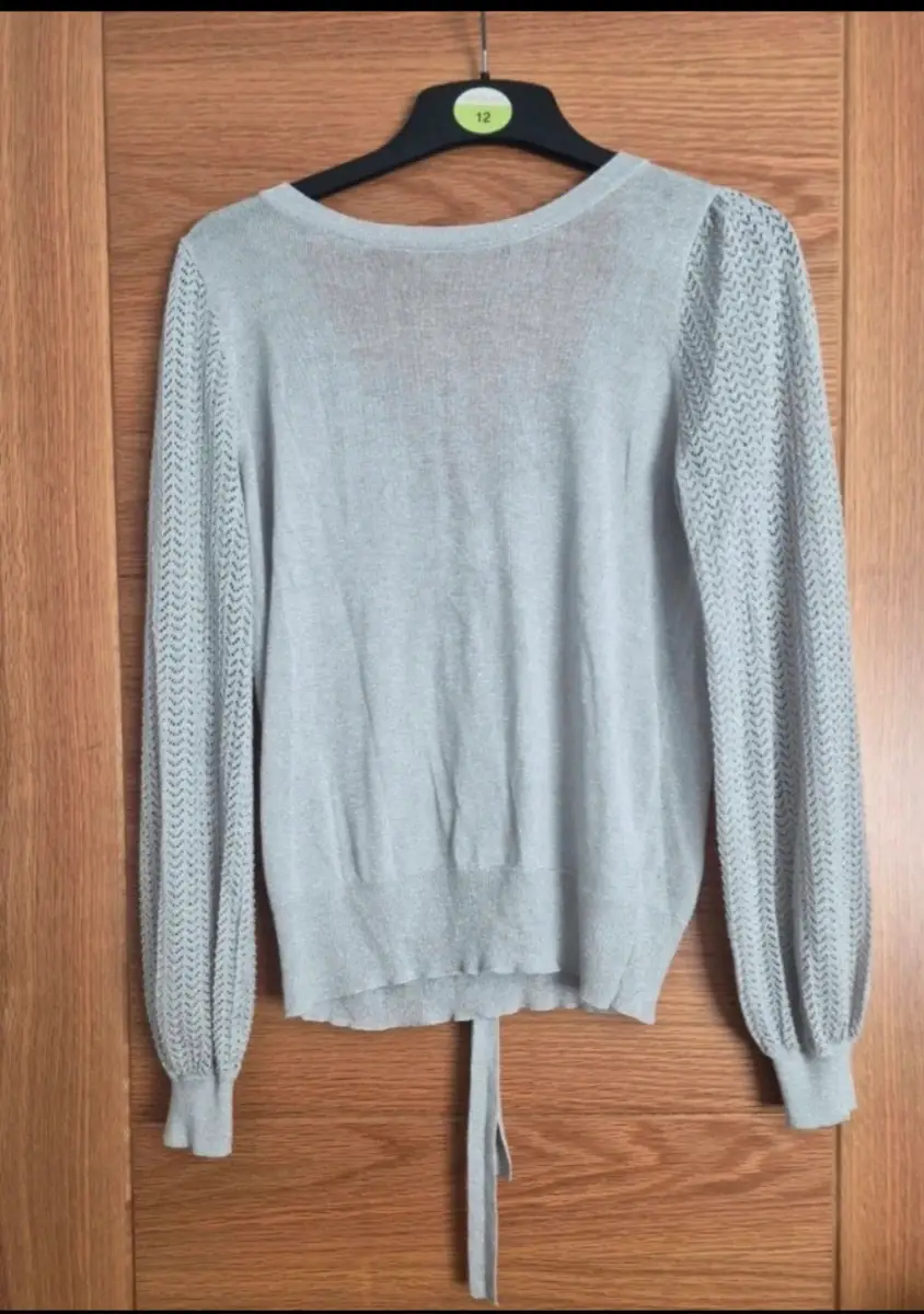 Silver fineknit jumper with open back. Like new. Worn once